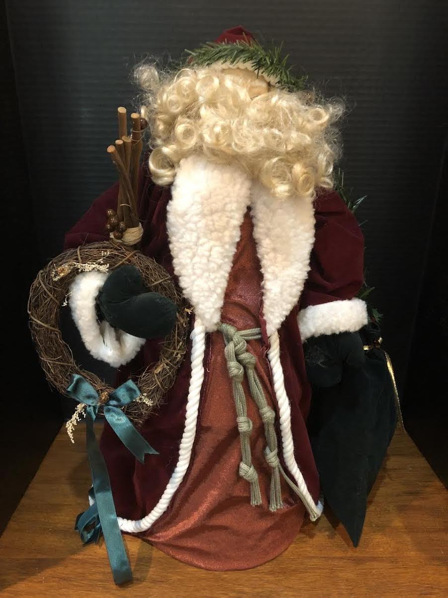 23" SANTA FIGURE IN LONG WINE COAT HOLDING WREATH AND BAG